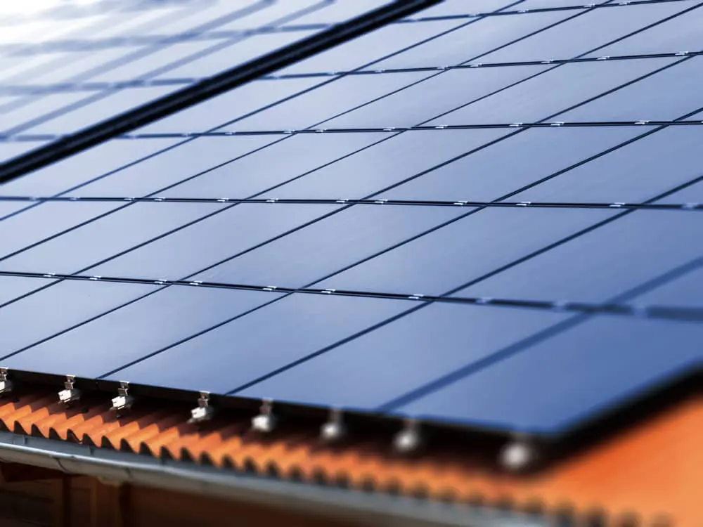 Solar panels on a residential roof top with tile shingles