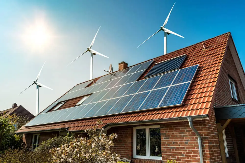 Solar panels on a tiled roof with windmills in the backyard