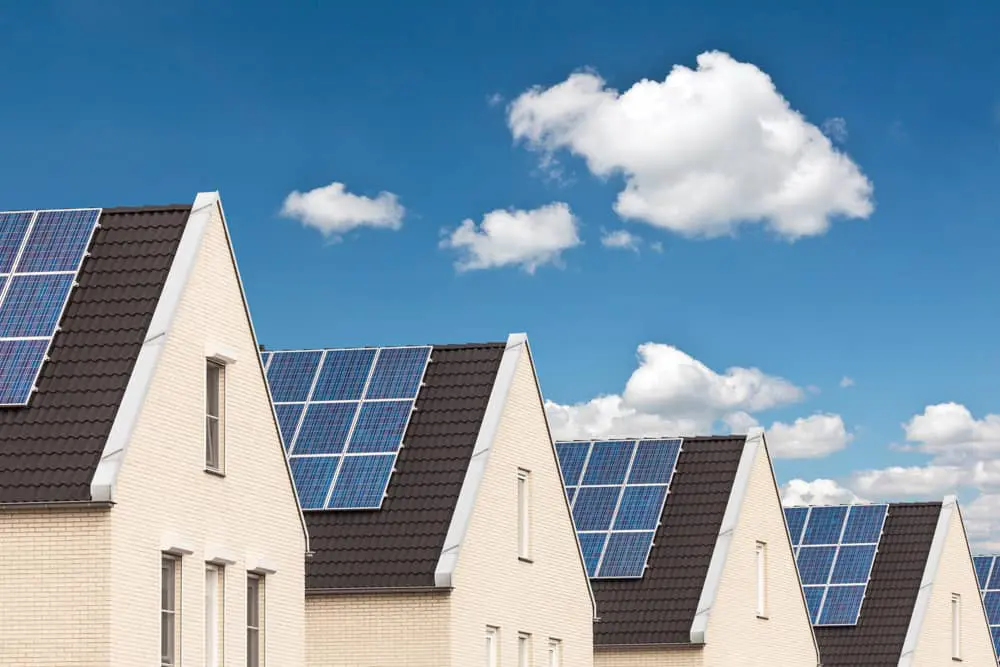 Four condos with solar panels in a sky view picture